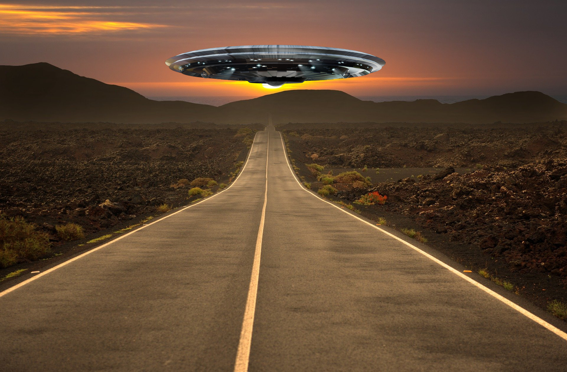 A depiction of a UFO above a road