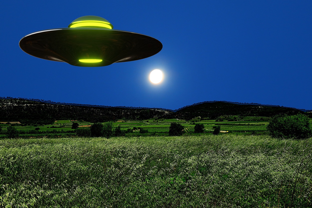 A depiction of a UFO over a field