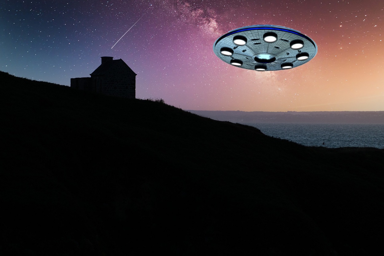 A depiction of a UFO at the coast over a house