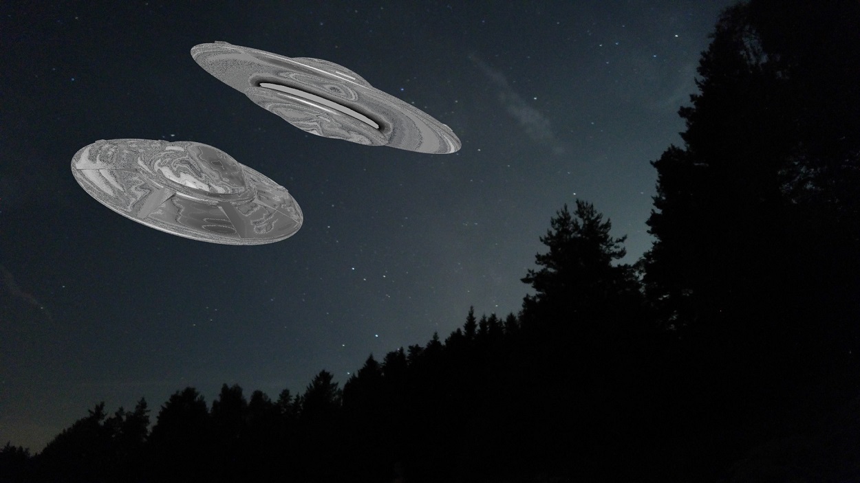 A depiction of two UFOs over the trees