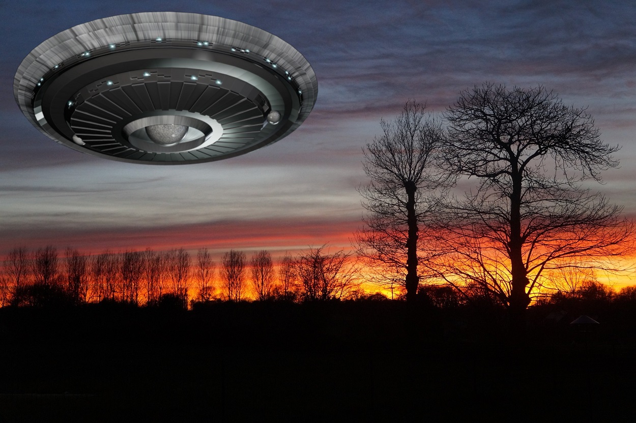 A depiction of a UFO over the treetops