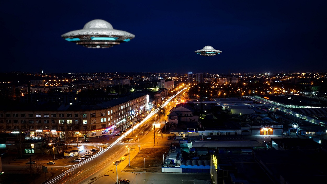 A picture of a UFO over a city at night
