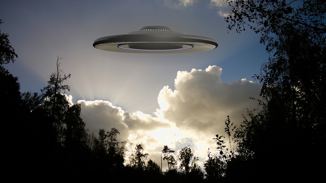 A picture of a UFO over the trees