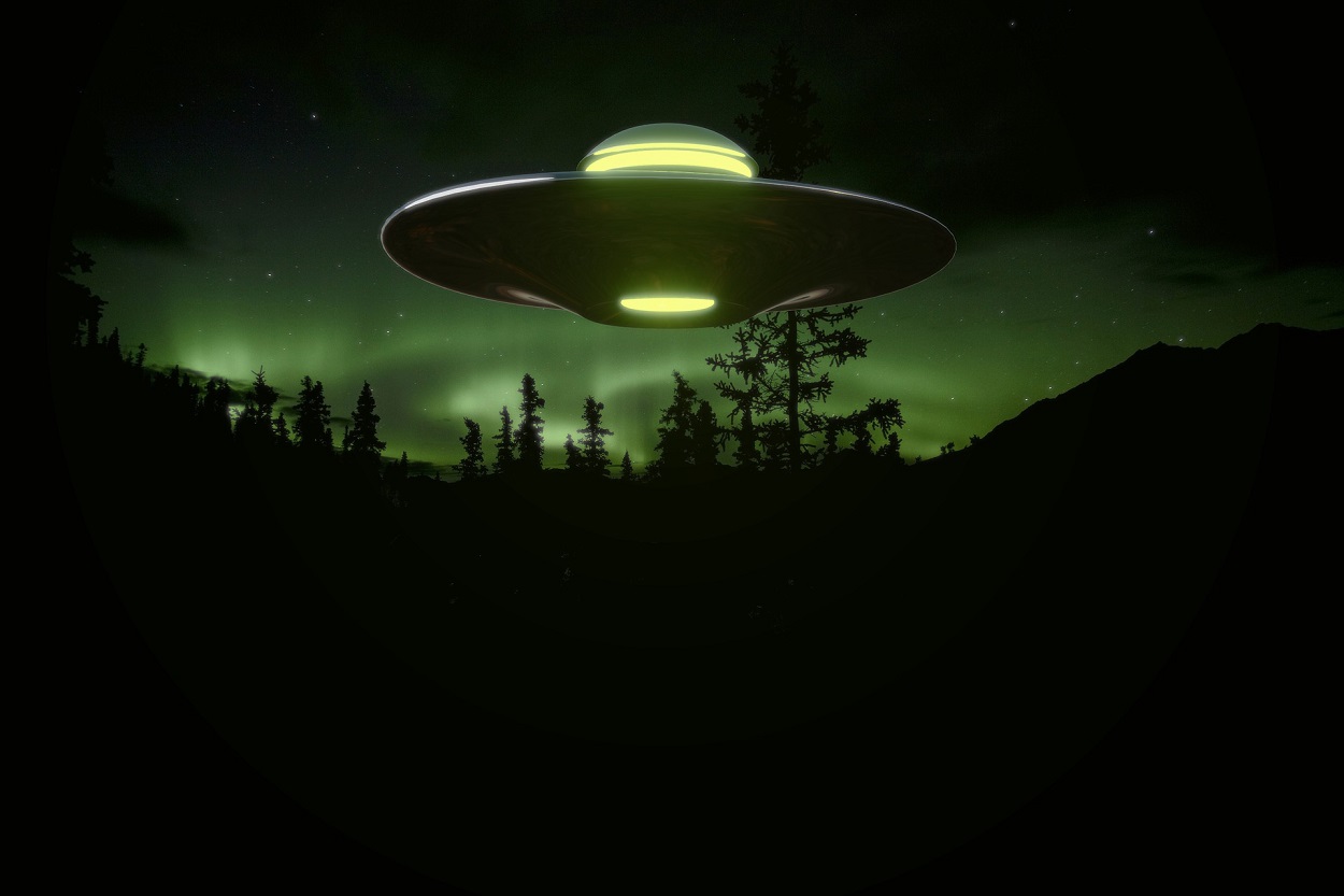A depiction of a UFO over woodland at night